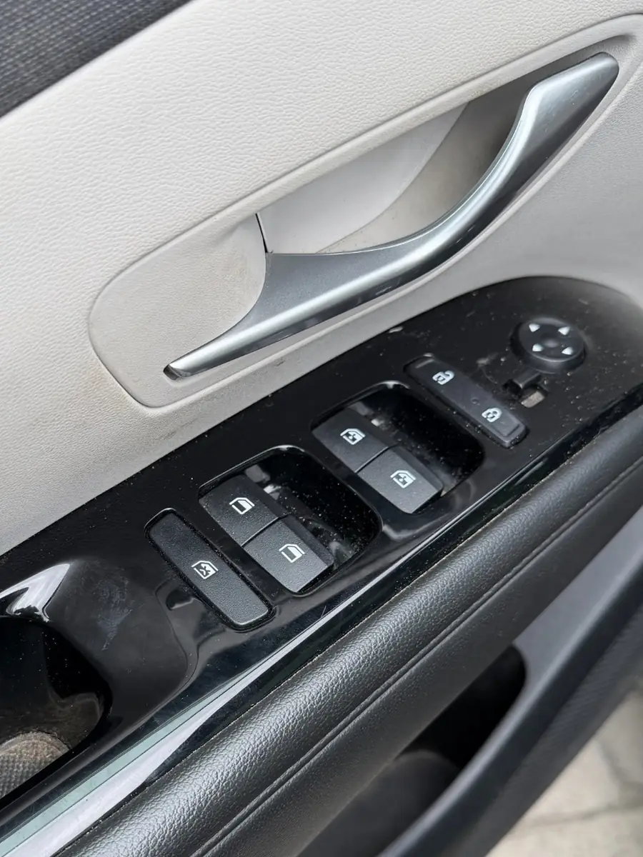 Hyundai Tucson — driver door controls and trim before detailing